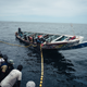 Local fishermen beat the sides of their boat and sing traditional songs as they pull their nets in.